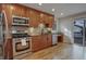 Well-equipped kitchen with stainless steel appliances, custom cabinetry, and hardwood floors at 4605 S Yosemite St # 39, Denver, CO 80237