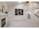 Bright living room featuring high ceilings, modern decor, fireplace, and staircase at 4605 S Yosemite St # 39, Denver, CO 80237