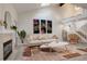 Bright living room featuring high ceilings, modern decor, fireplace, and staircase at 4605 S Yosemite St # 39, Denver, CO 80237