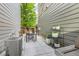 Cozy backyard features a patio with outdoor seating, string lights, and mature landscaping at 6058 Beeler Ct, Denver, CO 80238