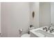 Well-lit half bathroom with modern fixtures, stylish vanity, and sleek design creates a fresh space at 6058 Beeler Ct, Denver, CO 80238