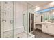 Sleek bathroom featuring a glass shower, tiled floor and vanity at 6058 Beeler Ct, Denver, CO 80238