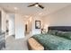 Comfortable bedroom with soft carpet, ceiling fan, and an ensuite bathroom at 6058 Beeler Ct, Denver, CO 80238