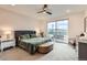 Modern bedroom with plush carpet, ceiling fan and sliding door to private balcony at 6058 Beeler Ct, Denver, CO 80238