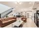 Open-concept living area with modern staircase seamlessly blends living, dining, and kitchen spaces at 6058 Beeler Ct, Denver, CO 80238