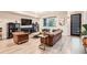 Stylish living room with leather couches, modern decor, and a large window offering natural light and views at 6058 Beeler Ct, Denver, CO 80238