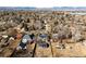 An aerial view of the neighborhood showcases the homes and street layout with mountain views in the background at 2360 Estes St, Lakewood, CO 80215