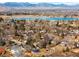 An aerial view highlighting the neighborhood's proximity to a beautiful lake and the surrounding landscape at 2360 Estes St, Lakewood, CO 80215