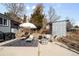 Backyard patio featuring an outdoor seating area with shade, lounge chairs, and a storage shed at 2360 Estes St, Lakewood, CO 80215