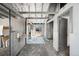 Barn interior featuring an open corridor with horse stalls, storage, and natural light at 2360 Estes St, Lakewood, CO 80215