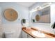 Charming bathroom with light blue walls, white tile accents, and vintage-style fixtures at 2360 Estes St, Lakewood, CO 80215