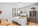 Bright bedroom with a comfortable bed, vintage furniture, and natural light from a window at 2360 Estes St, Lakewood, CO 80215