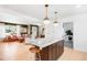 Open-concept kitchen with a large island, marble countertops, and adjacent living area at 2360 Estes St, Lakewood, CO 80215