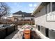 Outdoor dining area with modern black furniture, seating for 10, and patio with planters at 2360 Estes St, Lakewood, CO 80215