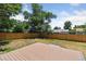 An open backyard with a wood fence, lush trees, and a modern composite deck at 2616 W 134Th Cir, Broomfield, CO 80020