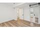 Bright bedroom featuring wood floors, fresh white walls, barn door, and closet entry at 2616 W 134Th Cir, Broomfield, CO 80020