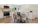 Cozy dining area featuring contemporary chairs, a modern light fixture, and updated appliances at 2616 W 134Th Cir, Broomfield, CO 80020