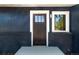 Close up view of a modern front door with decorative sidelight and well maintained lawn at 2616 W 134Th Cir, Broomfield, CO 80020