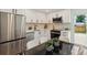 Stylish kitchen with stainless steel appliances, white cabinets, and modern fixtures at 2616 W 134Th Cir, Broomfield, CO 80020