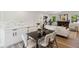 Stylish living room featuring a sleek dining set, modern art, and a cozy fireplace at 2616 W 134Th Cir, Broomfield, CO 80020