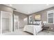 Bright bedroom with a large window, closet, and neutral gray walls at 12273 Karls Ln, Northglenn, CO 80241