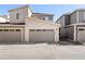 Exterior shot of townhome garage doors and street at 12273 Karls Ln, Northglenn, CO 80241