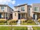 Charming modern townhome featuring a welcoming front porch and brick accents at 12273 Karls Ln, Northglenn, CO 80241