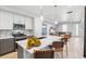 Stylish kitchen featuring a center island with barstool seating, stainless appliances and backsplash at 12273 Karls Ln, Northglenn, CO 80241