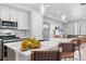 Bright kitchen featuring stainless appliances, a center island with sink and barstool seating at 12273 Karls Ln, Northglenn, CO 80241