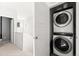 Convenient laundry area with a stacked washer and dryer unit at 12273 Karls Ln, Northglenn, CO 80241