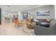 Bright living room with hardwood floors, stylish furniture, and a view into the kitchen at 12273 Karls Ln, Northglenn, CO 80241