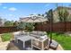 Backyard patio with outdoor seating, a large umbrella, and a well-maintained lawn at 16164 E Hinsdale Ave, Aurora, CO 80016