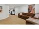 Finished basement with modern artwork, a plush sofa, and a dedicated workout area at 16164 E Hinsdale Ave, Aurora, CO 80016