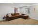 Finished basement featuring neutral carpet, stylish artwork, and a comfortable sectional sofa at 16164 E Hinsdale Ave, Aurora, CO 80016