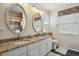 Bathroom featuring double sinks, granite countertop, and zebra print valances at 16164 E Hinsdale Ave, Aurora, CO 80016