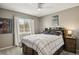 Bedroom featuring a window, a bed with a black and white blanket, and fan at 16164 E Hinsdale Ave, Aurora, CO 80016