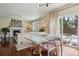Open dining area features glass table with gold accents, view of backyard, and adjacent living area at 16164 E Hinsdale Ave, Aurora, CO 80016