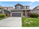 Charming two-story home with a gray facade, well-maintained lawn, and a convenient two-car garage at 16164 E Hinsdale Ave, Aurora, CO 80016