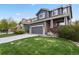 Beautiful two-story home featuring a lush green lawn, gray exterior, and an attached two-car garage at 16164 E Hinsdale Ave, Aurora, CO 80016