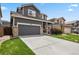 Attractive two-story home featuring a well-manicured lawn, gray exterior, and an attached two-car garage at 16164 E Hinsdale Ave, Aurora, CO 80016