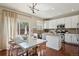 Bright kitchen features granite countertops, modern appliances, and a glass table with backyard view at 16164 E Hinsdale Ave, Aurora, CO 80016