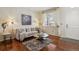 Cozy living room featuring hardwood floors, comfortable seating, and a well-lit ambiance at 16164 E Hinsdale Ave, Aurora, CO 80016