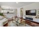 Spacious living area with a modern interior and views into kitchen at 16164 E Hinsdale Ave, Aurora, CO 80016