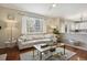 Bright living room featuring modern sofa, fireplace, and hardwood floors at 16164 E Hinsdale Ave, Aurora, CO 80016