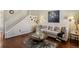 Inviting living room with hardwood floors, neutral decor, and a stylish staircase at 16164 E Hinsdale Ave, Aurora, CO 80016