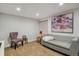 Living room with a grey couch, and colorful piece of artwork on the wall at 16164 E Hinsdale Ave, Aurora, CO 80016
