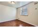 Simple bedroom with neutral walls, window with blinds, and vinyl flooring at 13343 E Louisiana Ave, Aurora, CO 80012