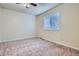 Bright bedroom with a ceiling fan, neutral carpet and a large window, providing ample natural light at 13343 E Louisiana Ave, Aurora, CO 80012