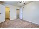 Spacious bedroom with neutral walls, ceiling fan, and multiple doors at 13343 E Louisiana Ave, Aurora, CO 80012