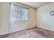 Bright bedroom featuring neutral walls, blinds, and wall clock at 13343 E Louisiana Ave, Aurora, CO 80012